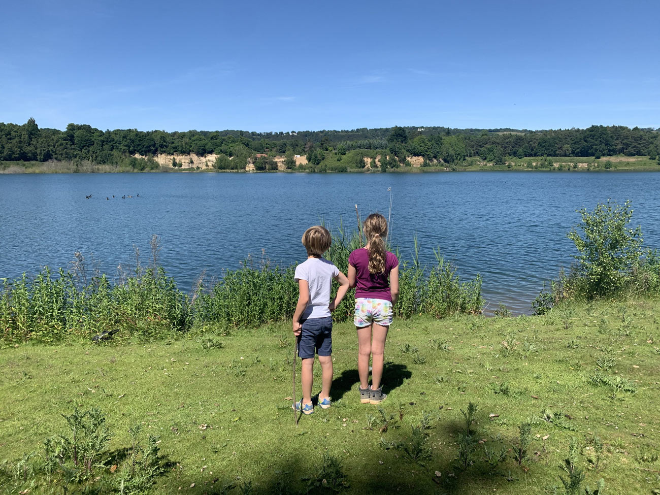 two children looking at a freshwater lake
